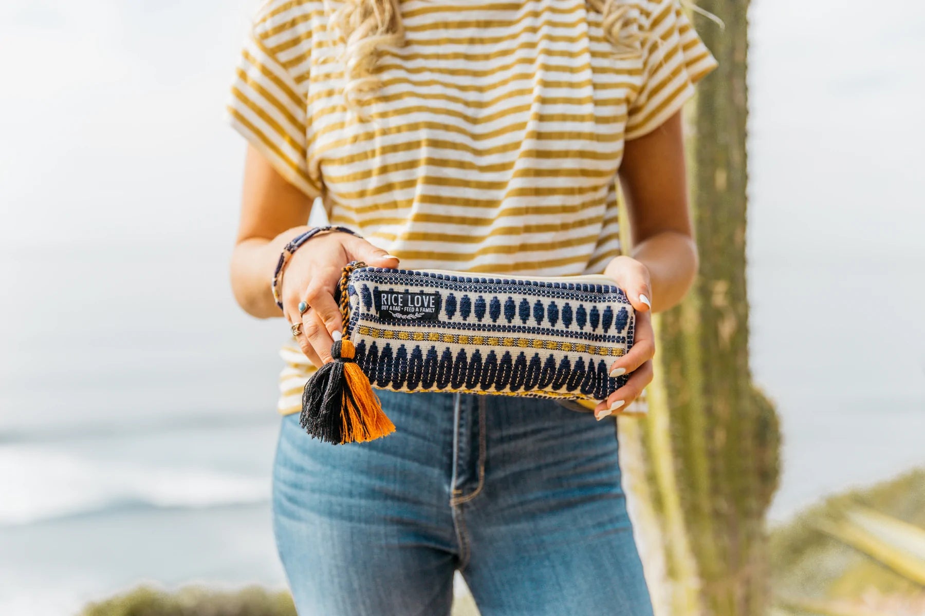 A person holds in front of them a handmade burlap pouch