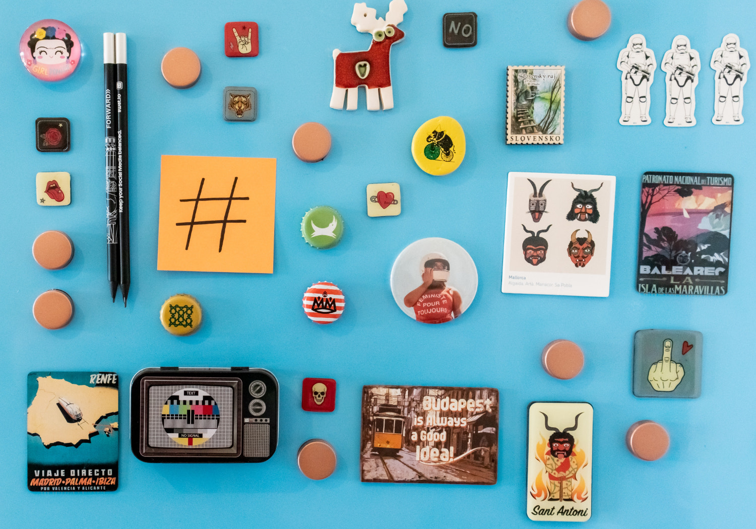 A blue fridge covered in magnets