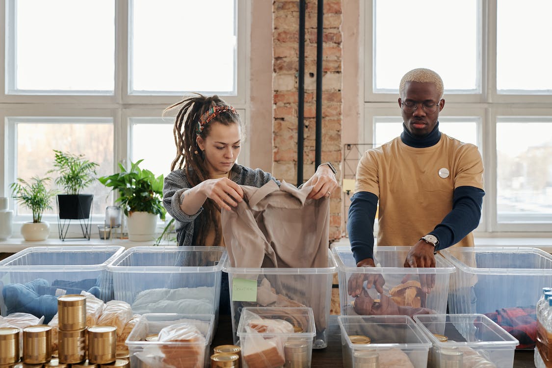 Two people working at a donation center.