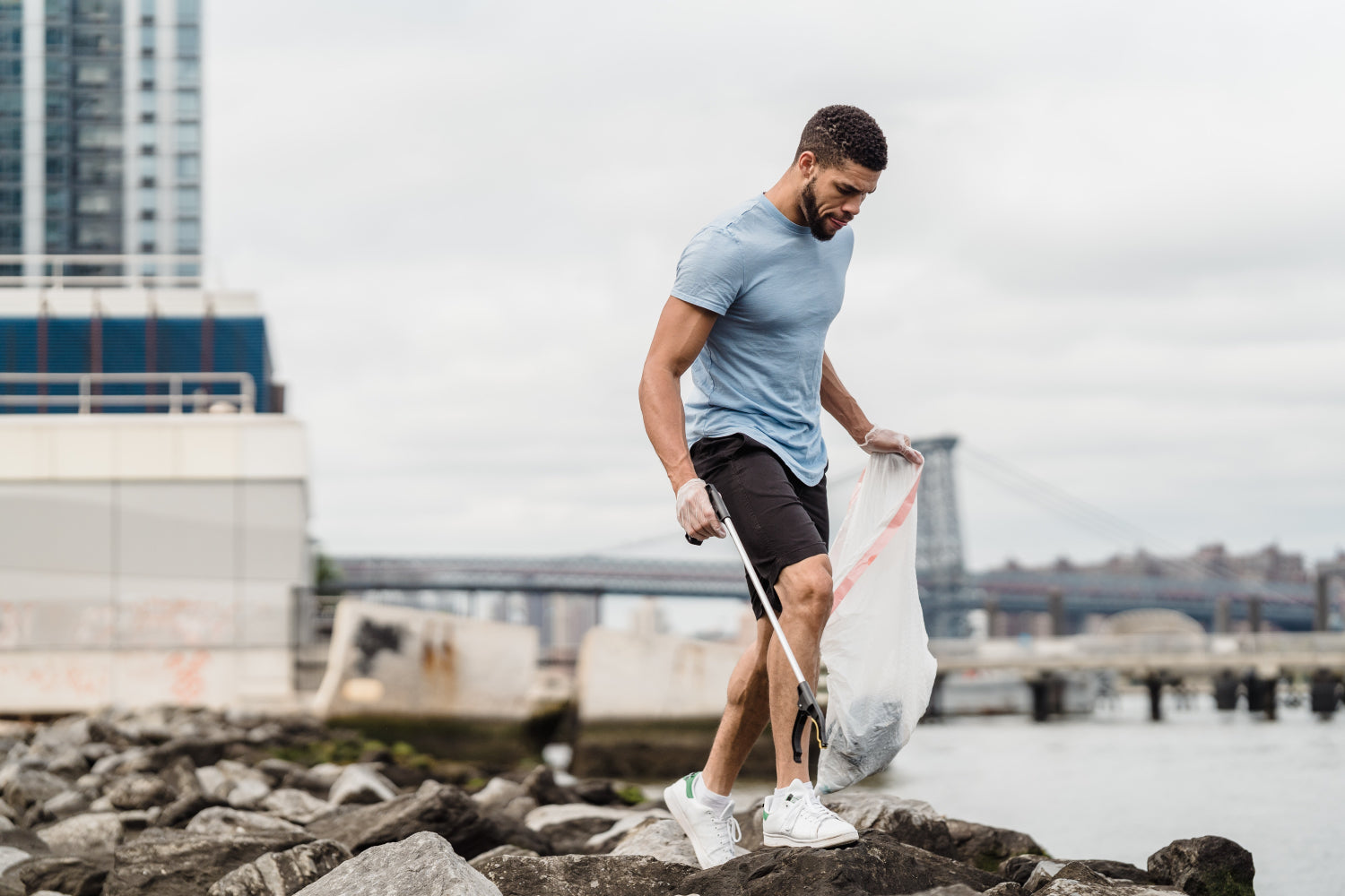 A man collects garbage on the beach