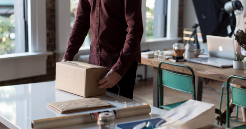 Man measuring a box with string